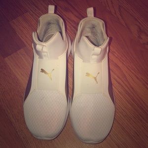 Women white and gold Pumas.